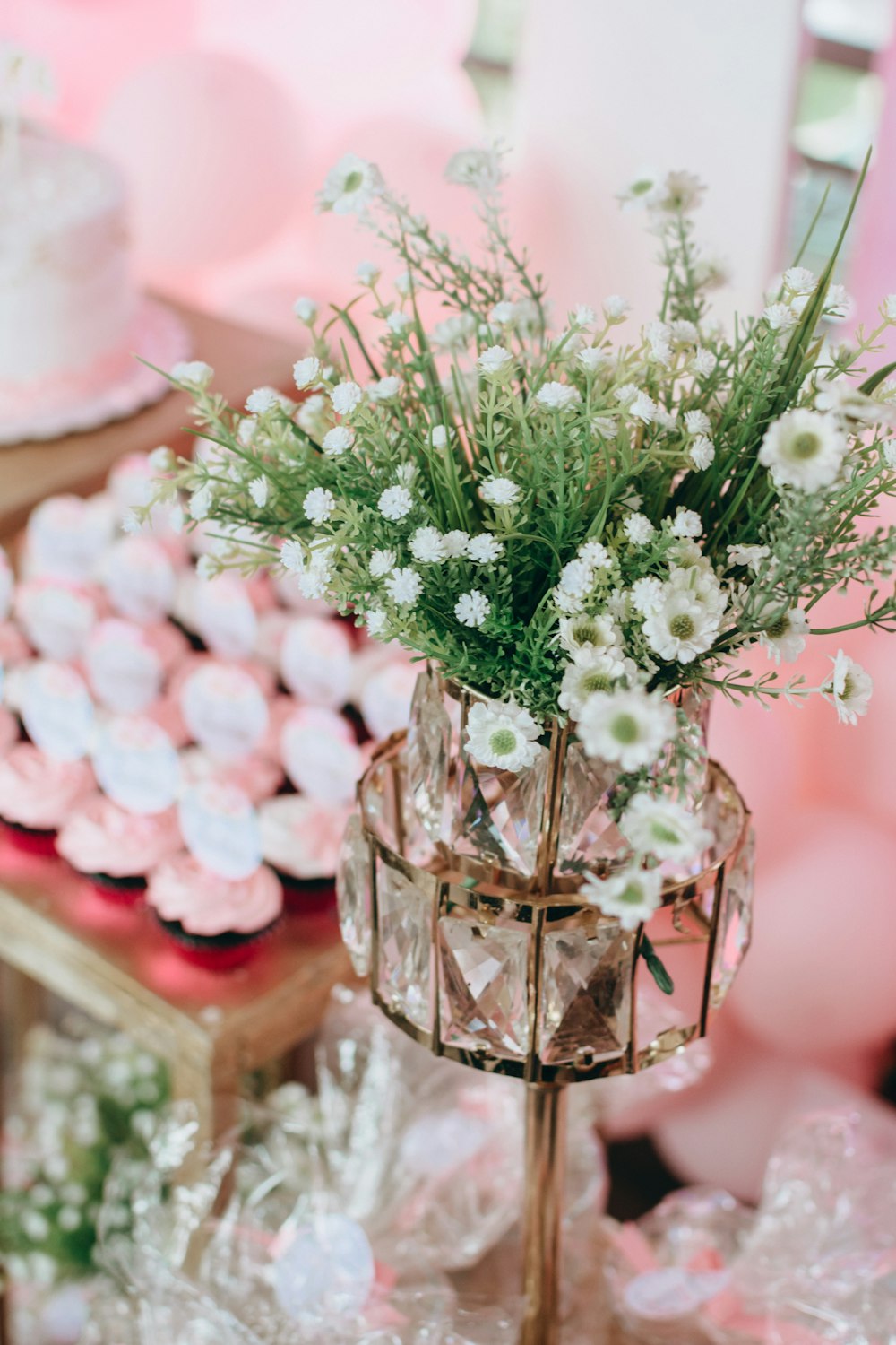 a vase filled with white flowers sitting on top of a table