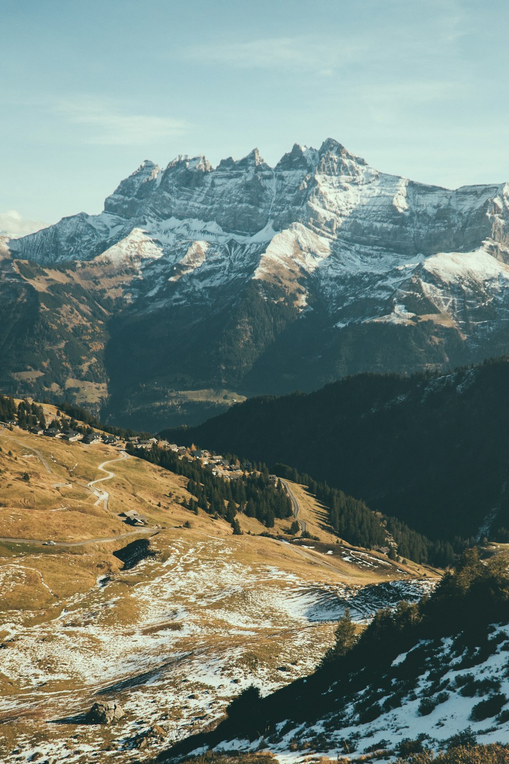 a mountain range with snow covered mountains in the background