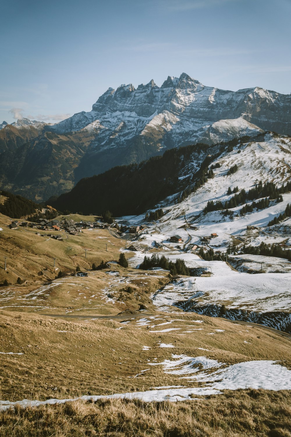 a snow covered mountain range with a path in the foreground