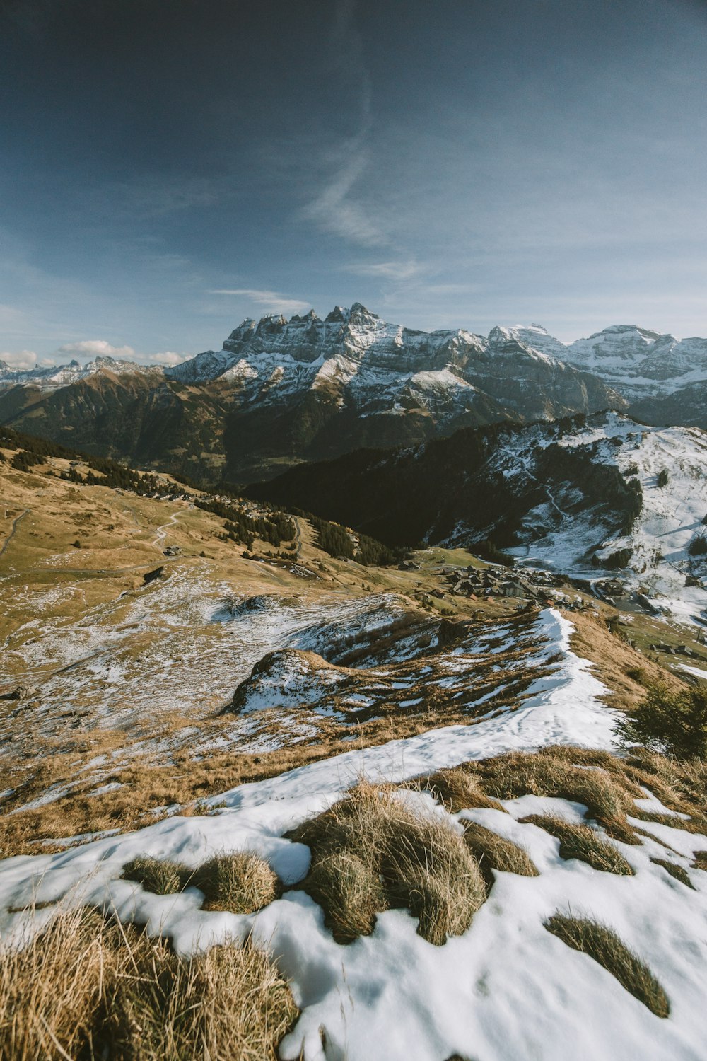 a snow covered field with mountains in the background