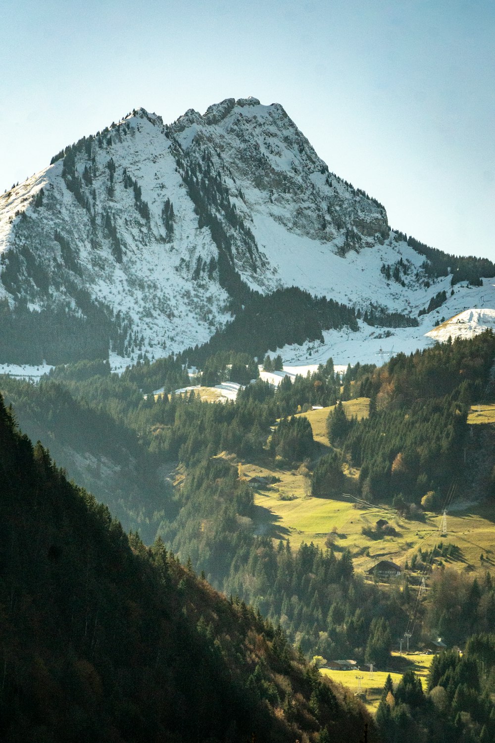 a snow covered mountain with a valley below