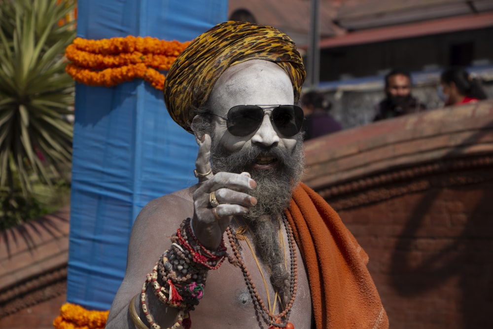 a man with a beard wearing sunglasses and a turban