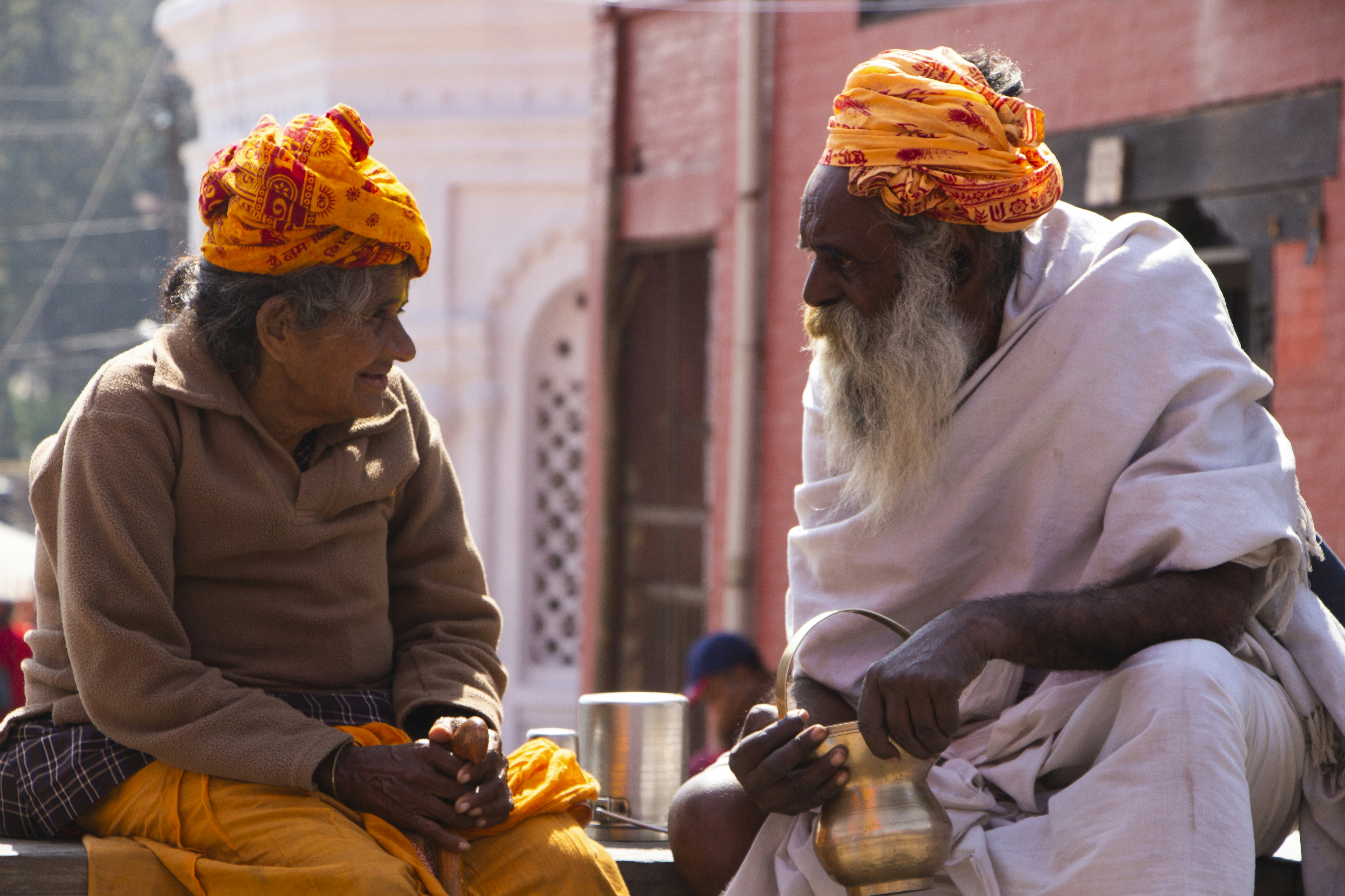 a couple of men sitting next to each other
