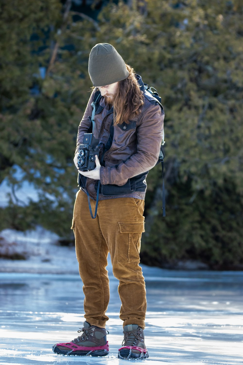 a person standing on a frozen surface with a backpack