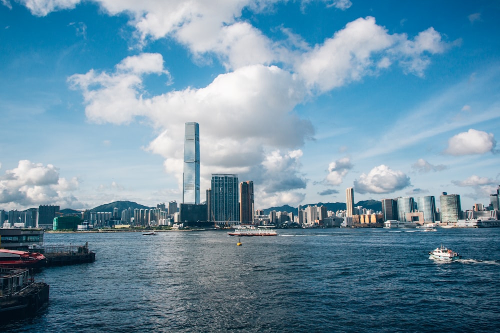 a small boat in a body of water with a city in the background