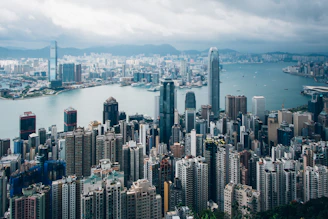 Hong Kong's vibrant cityscape with densely packed skyscrapers and Victoria Harbour in the background.