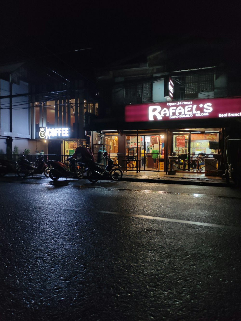 a motorcycle parked in front of a store at night
