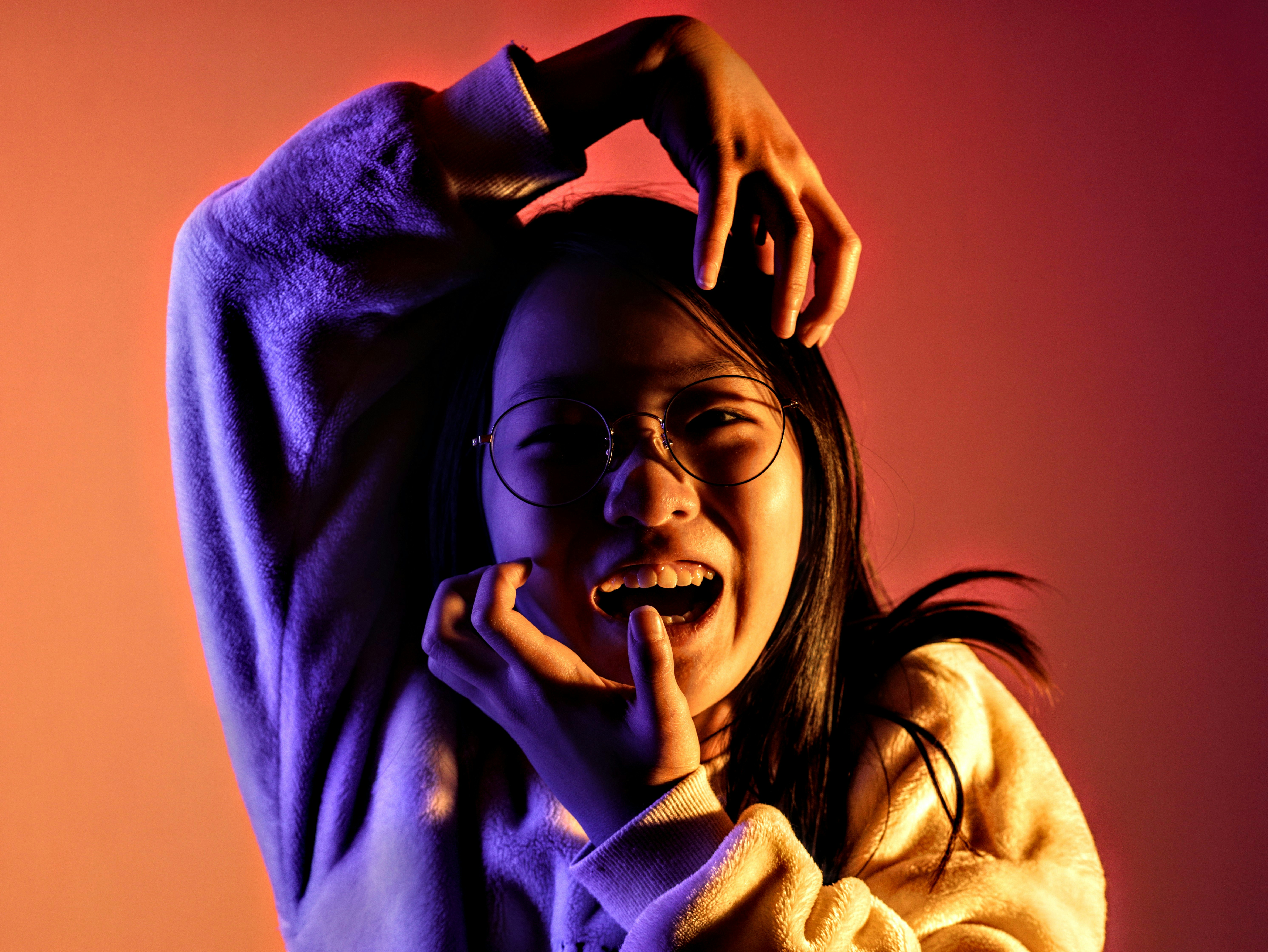 a young girl wearing glasses and a sweater