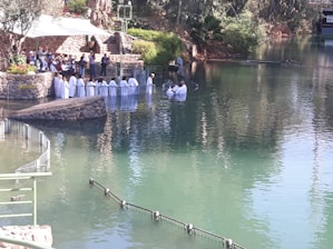 a group of people standing in the middle of a lake