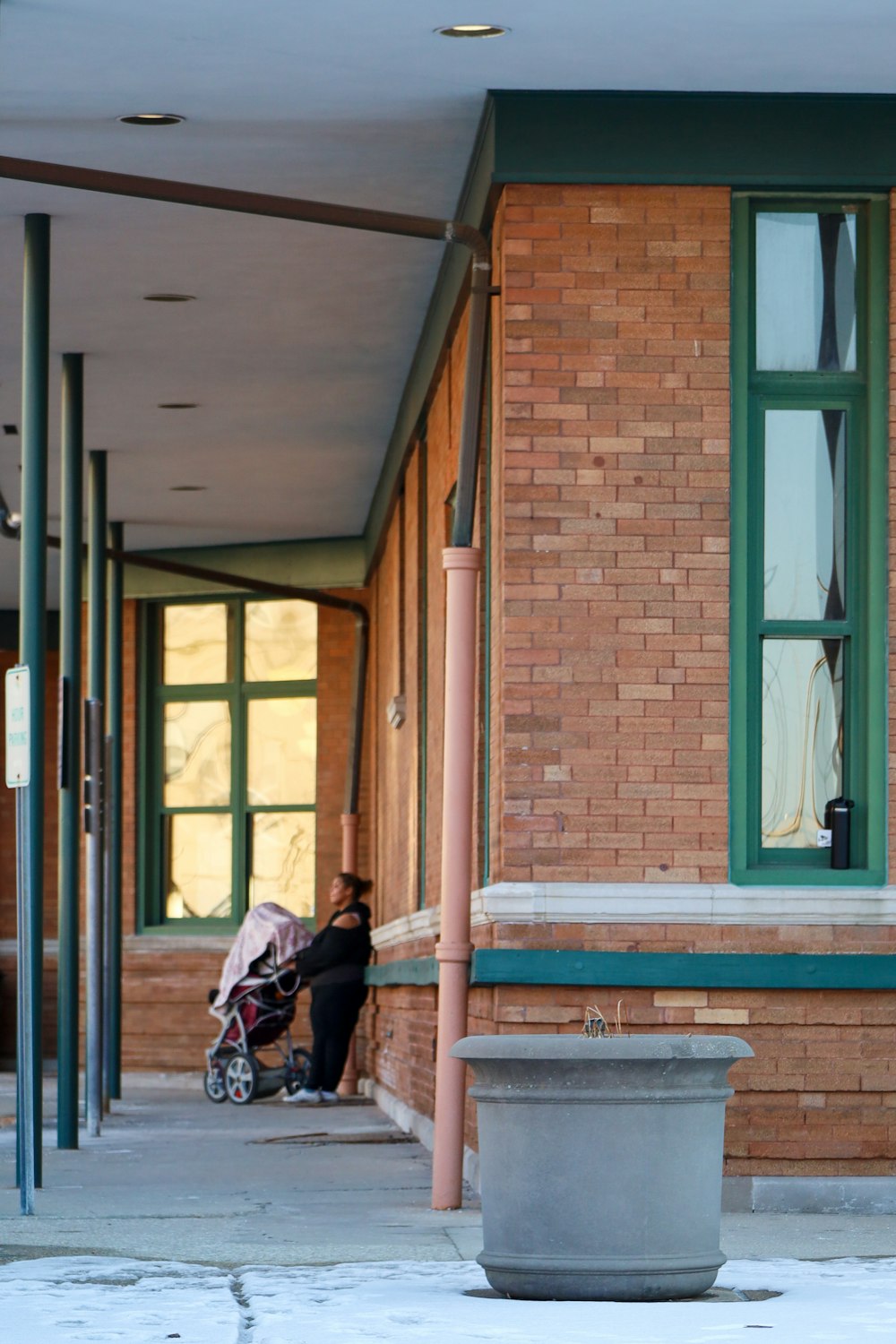 a person sitting on a bench in front of a building