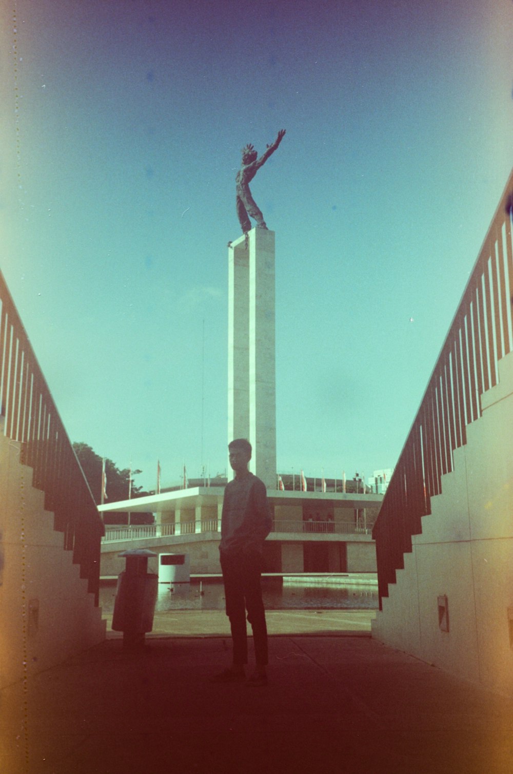 a man standing in front of a tall monument