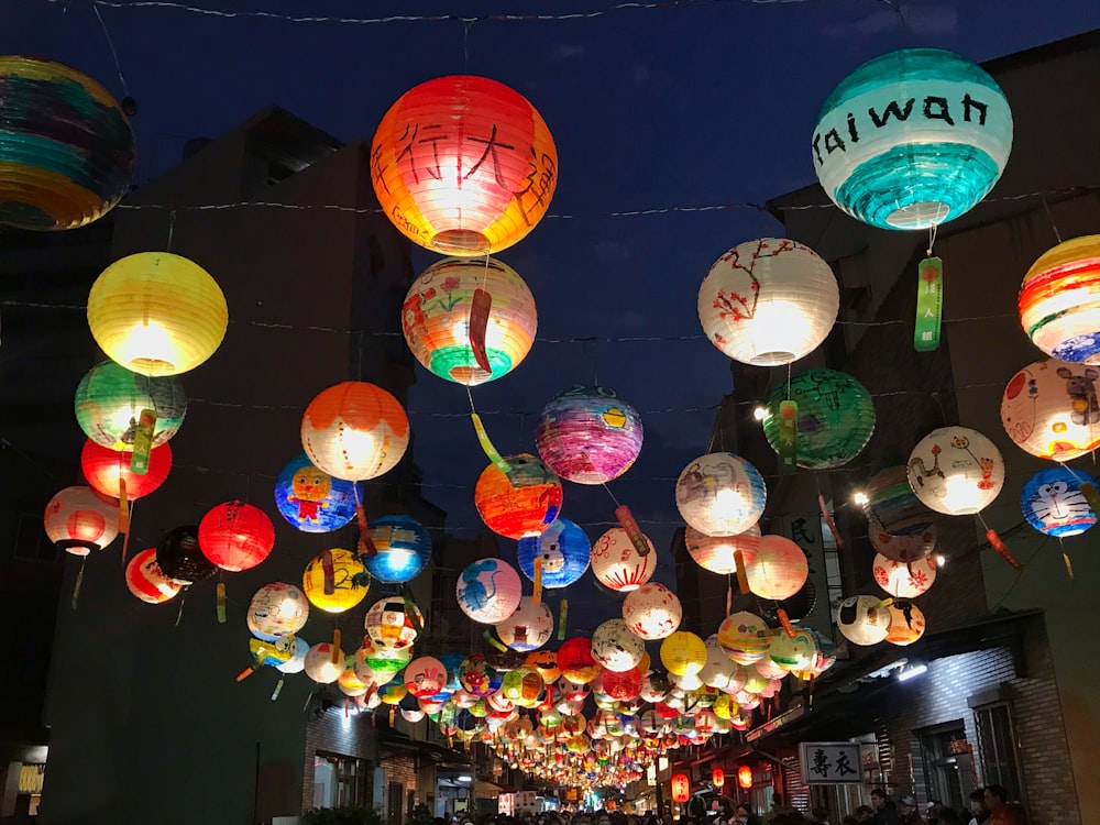 a bunch of paper lanterns hanging from the ceiling