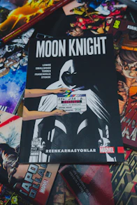 a pile of comic books sitting on top of a table