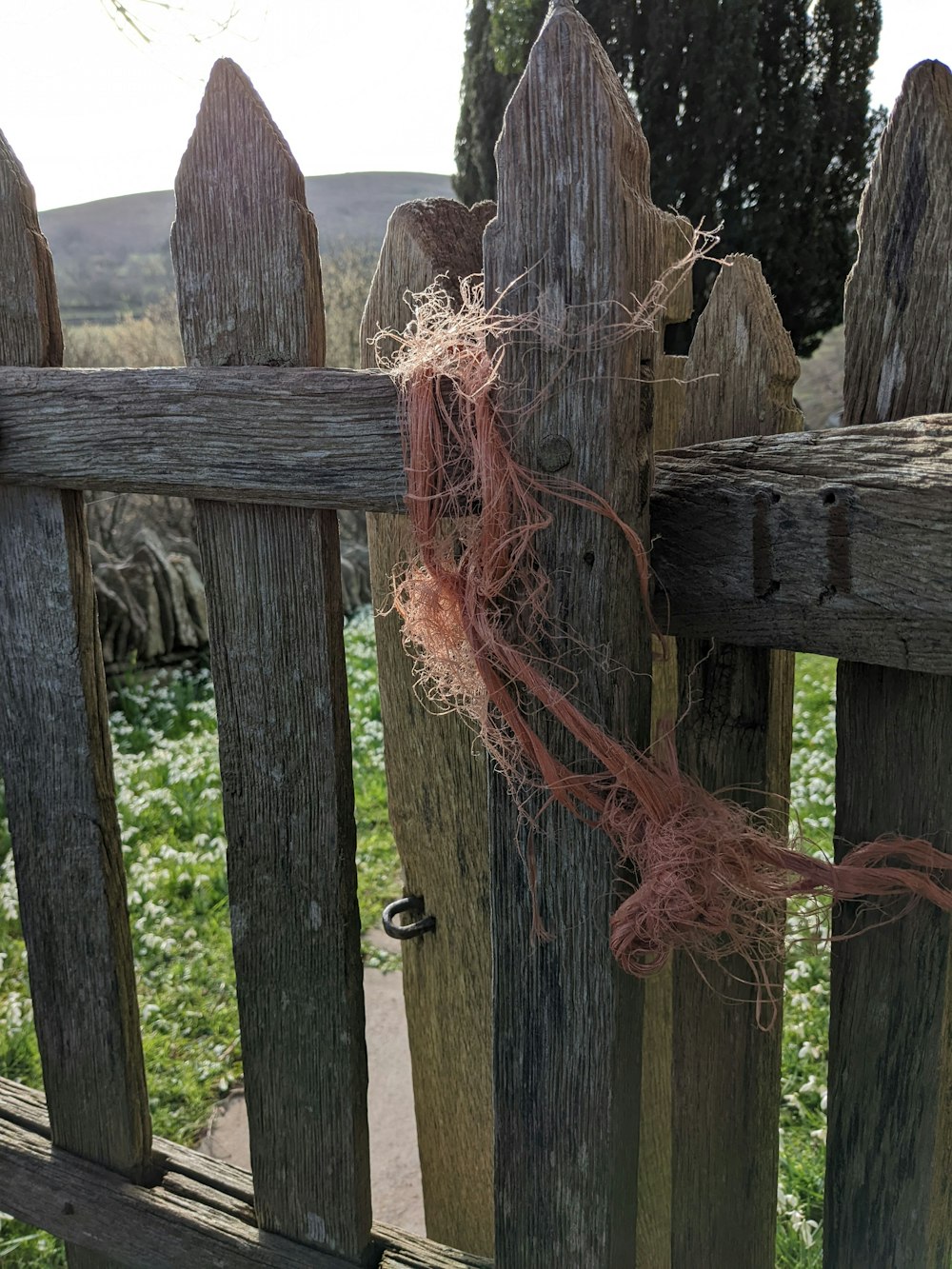a wooden fence with a knot tied to it