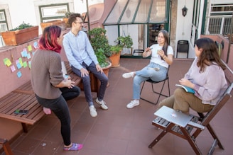 a group of people sitting around a wooden bench