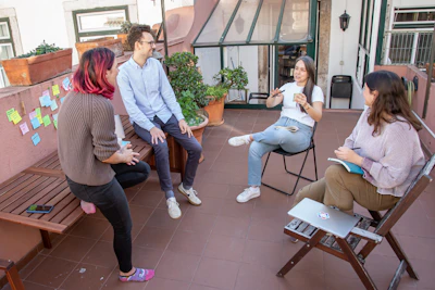a group of people sitting around a wooden bench