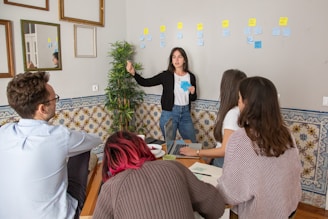 a group of people sitting around a wooden table