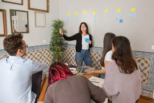 a group of people sitting around a wooden table