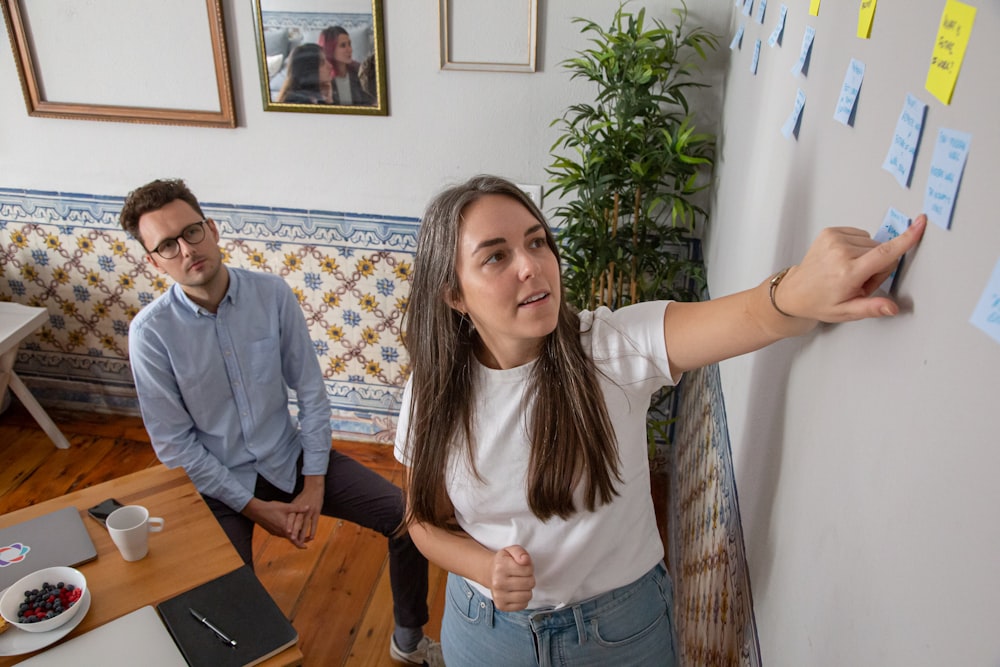 a man and a woman standing in front of a whiteboard