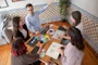 a group of people sitting around a wooden table