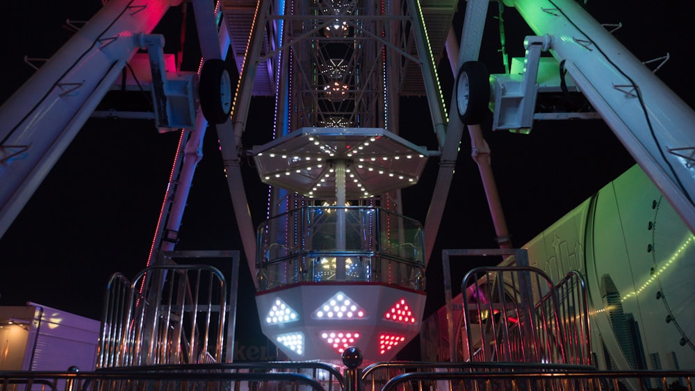 a ferris wheel lit up at night at a carnival