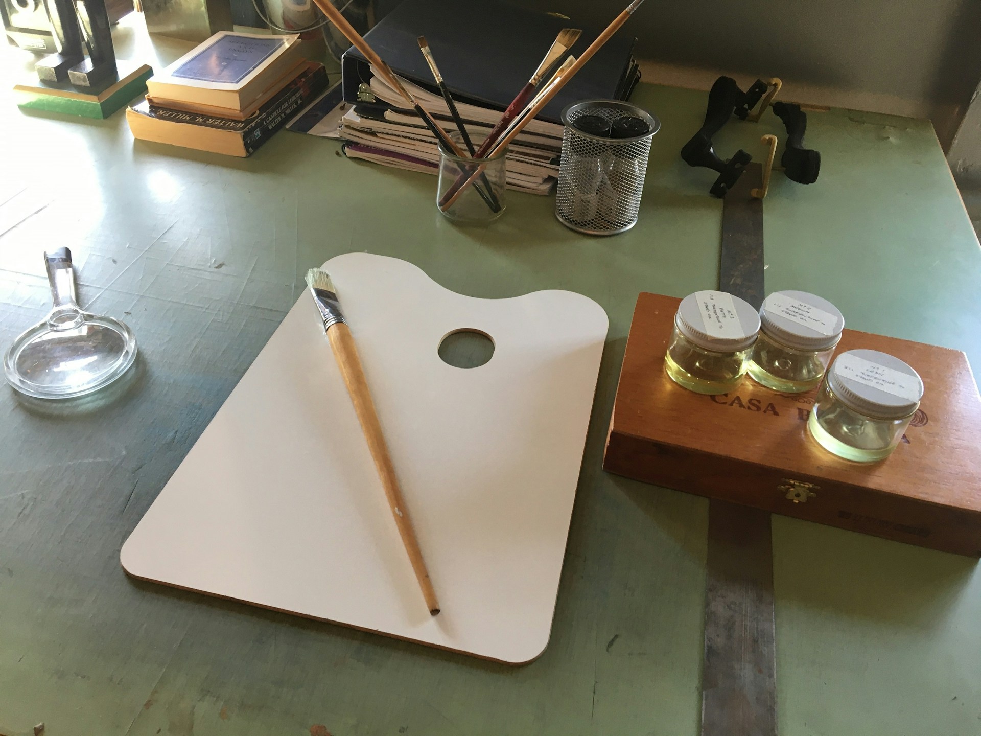 A serene photography shot of an artist's workspace, featuring tools and materials for creative projects.