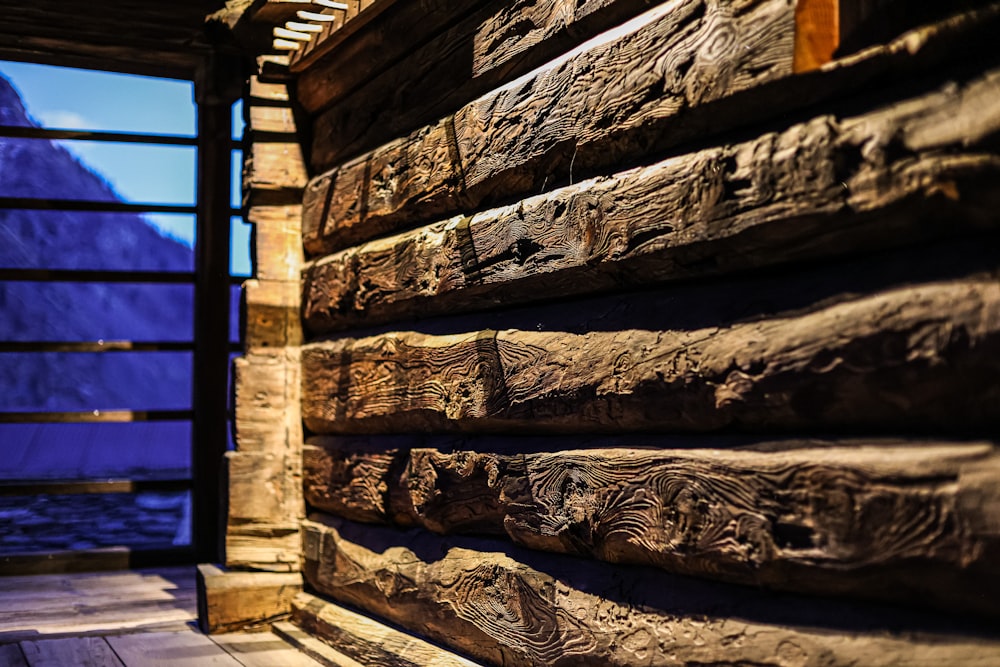 a close up of a wooden structure with a mountain in the background