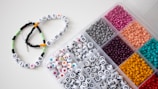 a box filled with lots of different colored beads
