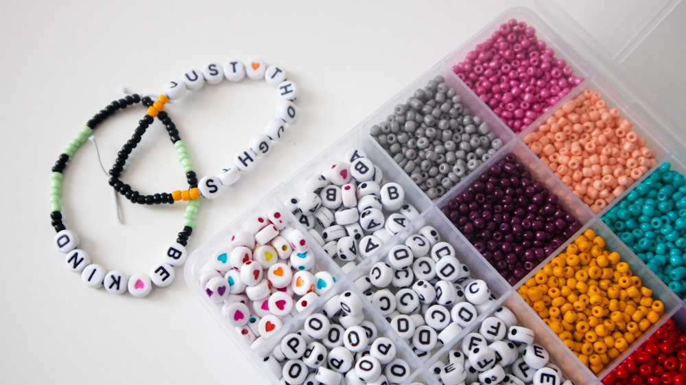 a box filled with lots of different colored beads