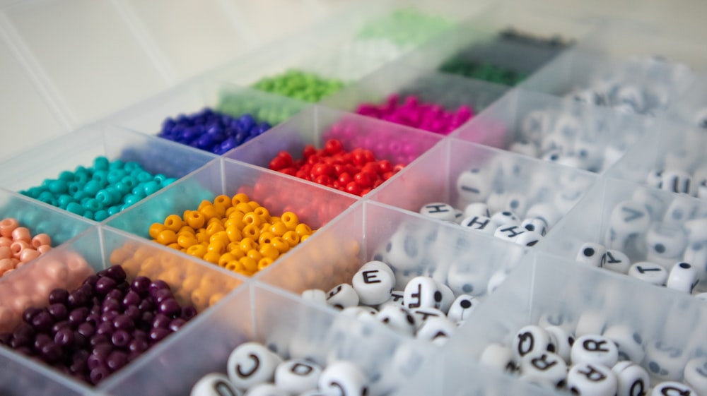 a box filled with lots of different colored beads