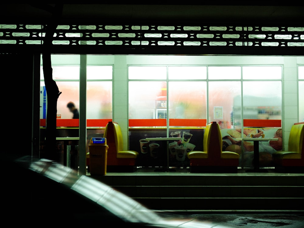 a train car with people sitting on it at night