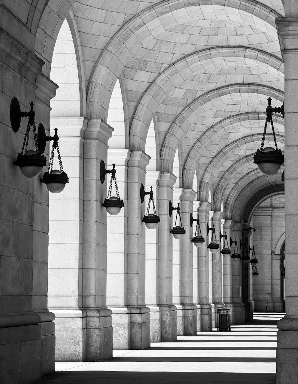 a black and white photo of a row of pillars with scales on them