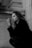 a woman sitting on the ground smoking a cigarette