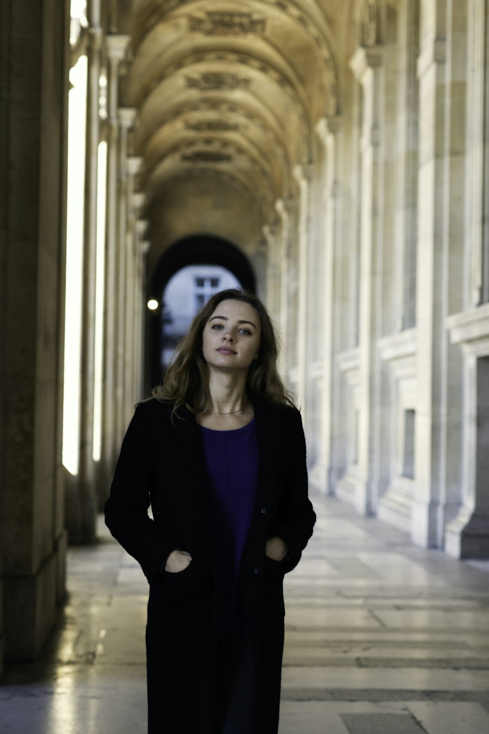 a woman standing in a hallway in a building