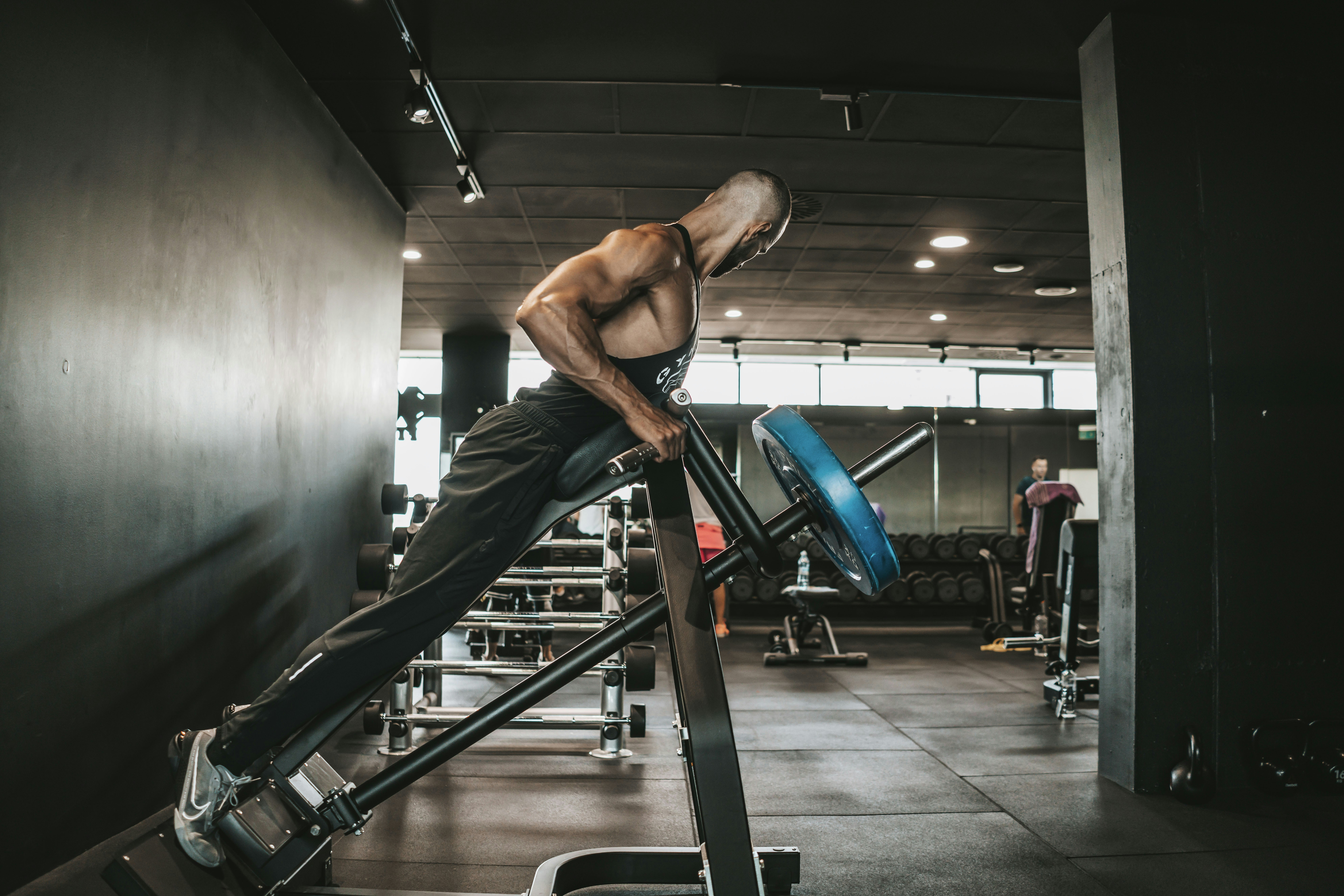 A runner on a treadmill inside a gym, focusing on their form and breathing - Endurance running program