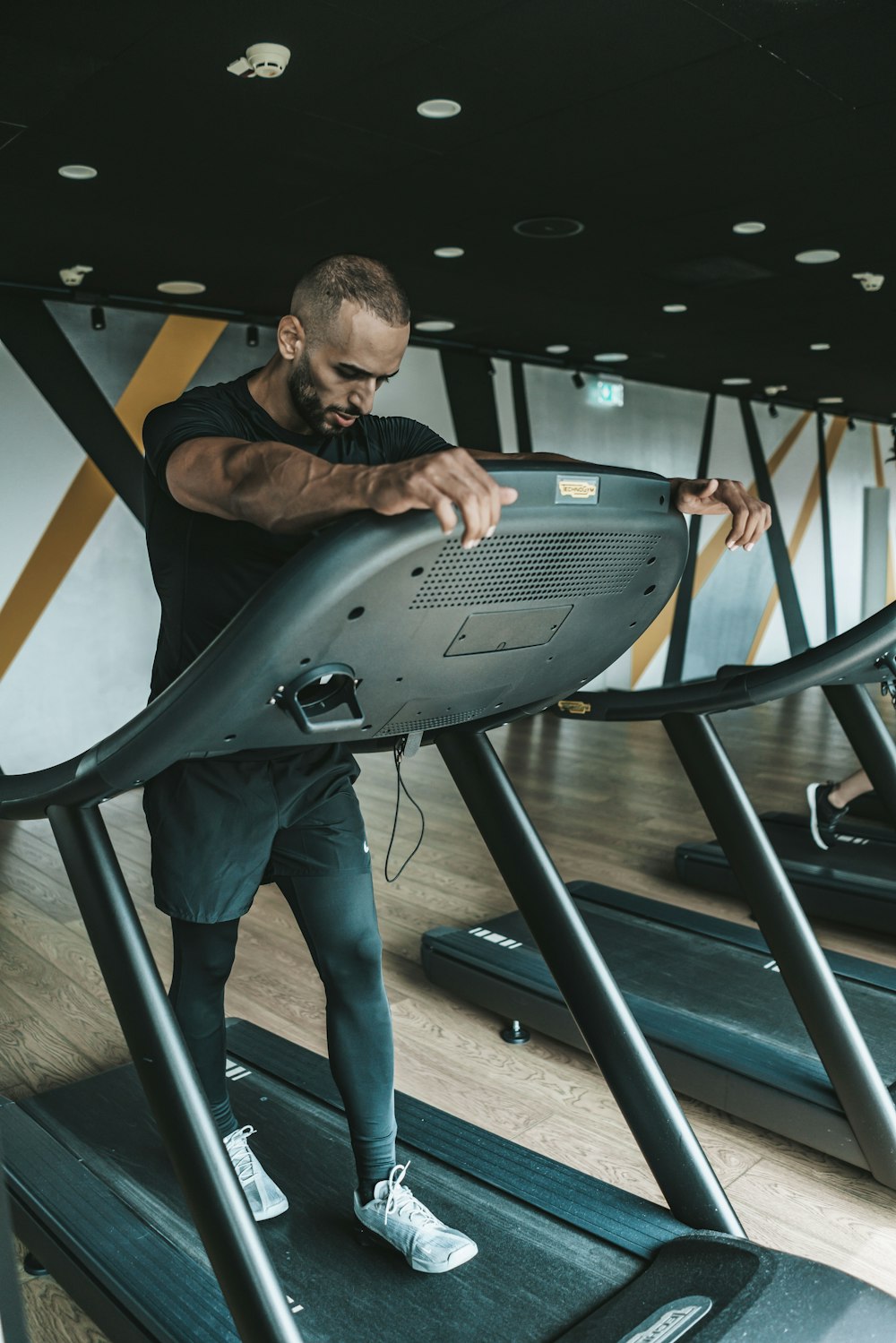 a man is running on a treadmill