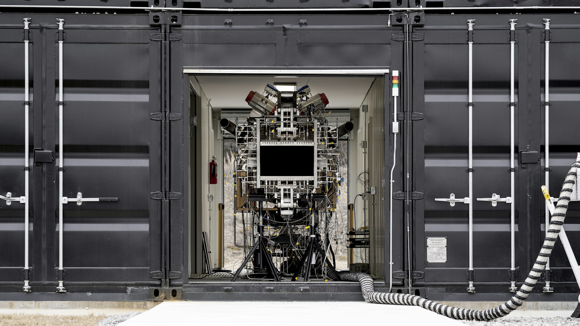 a black and white photo of a machine in a container