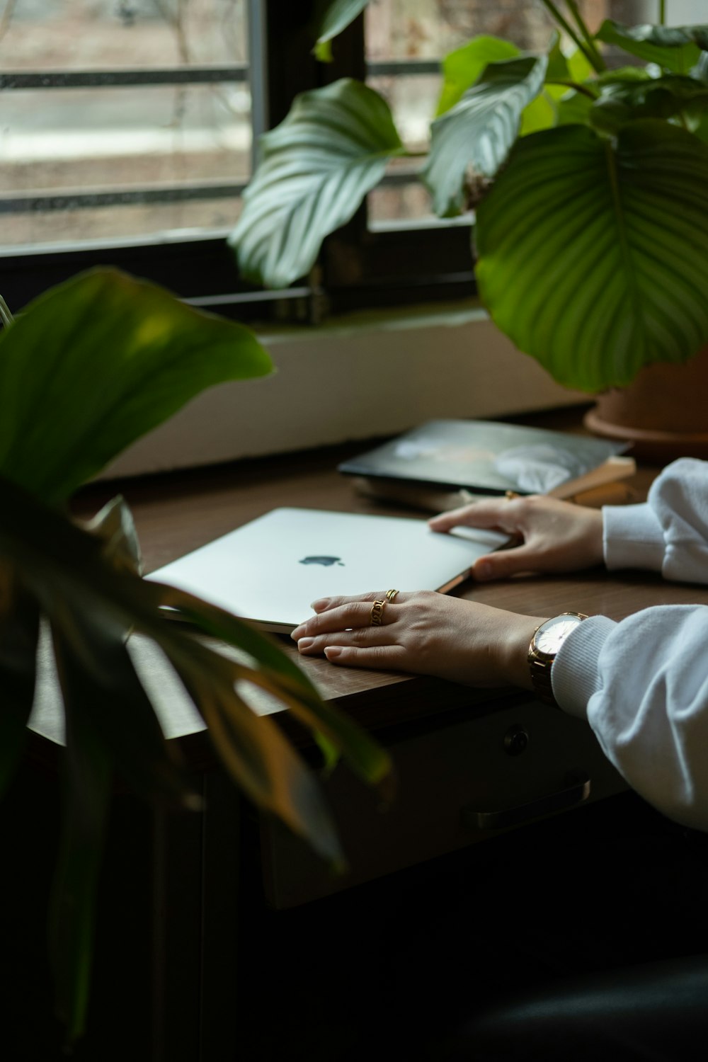 a person sitting at a desk using a laptop computer