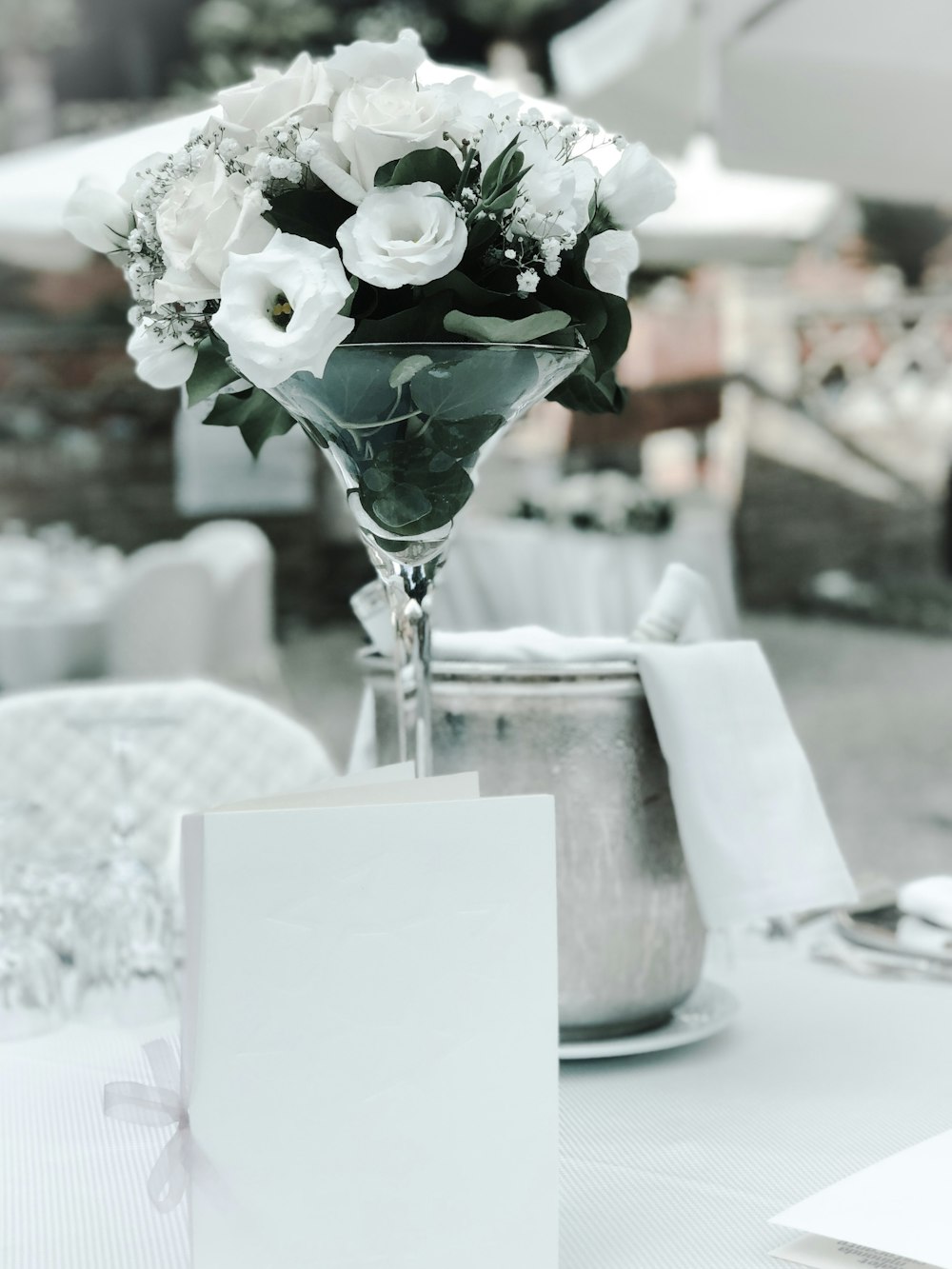 a table with a card and flowers on it