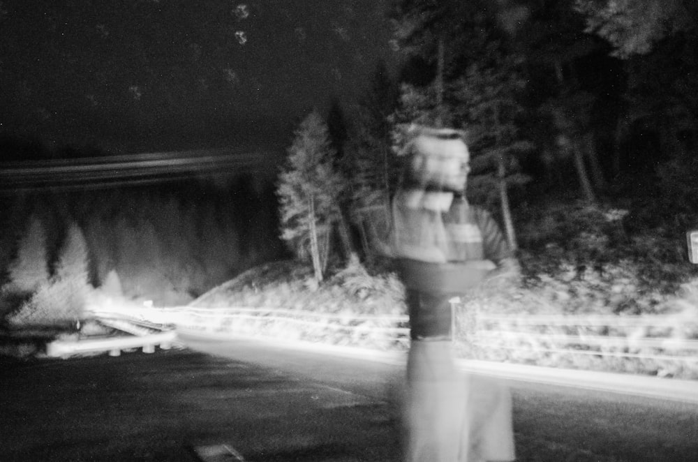 a blurry image of a person walking down a street