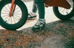 a person standing next to a red bike