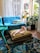 A cozy living room with a cat lounging on a stylish sofa, surrounded by various cat toys.