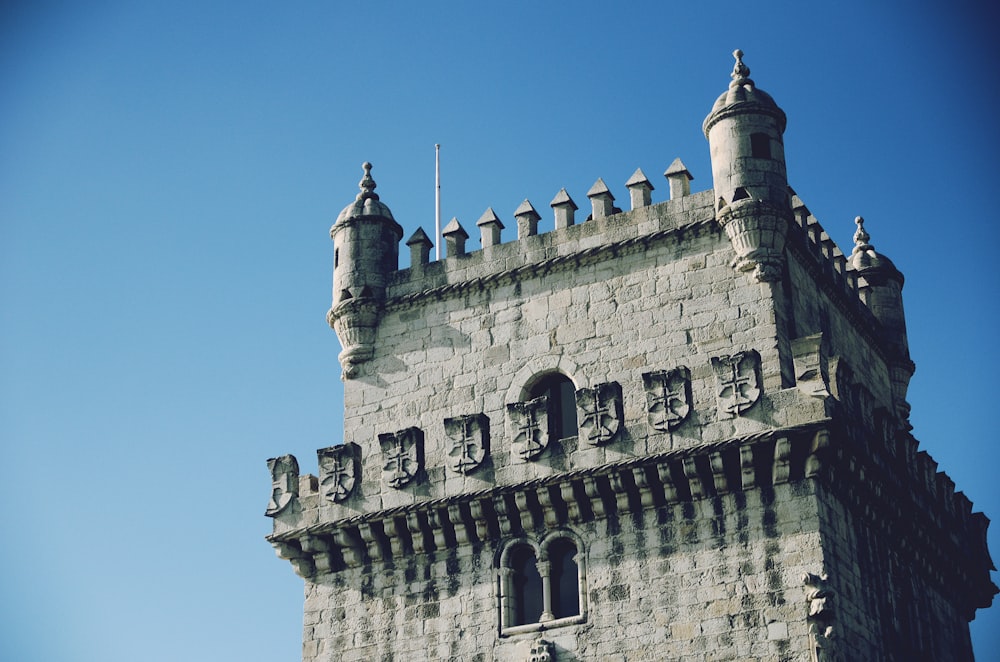 a very tall tower with a clock on it's side