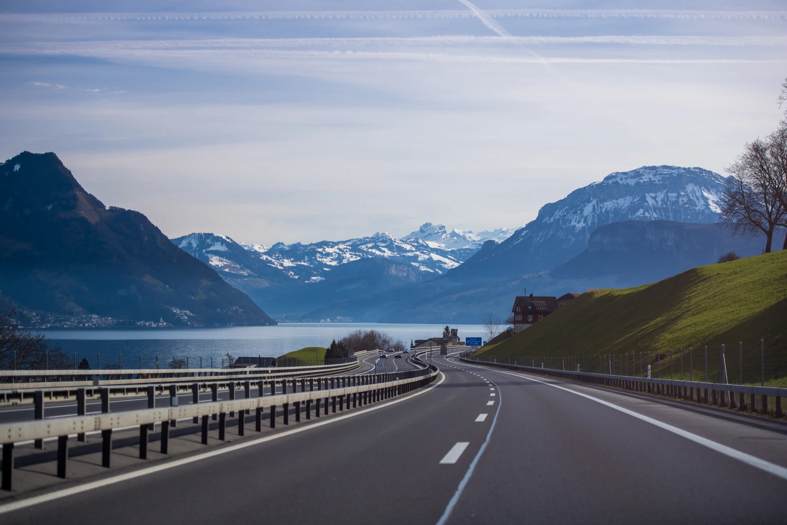 Road beside a Swiss lake with mountains across the water