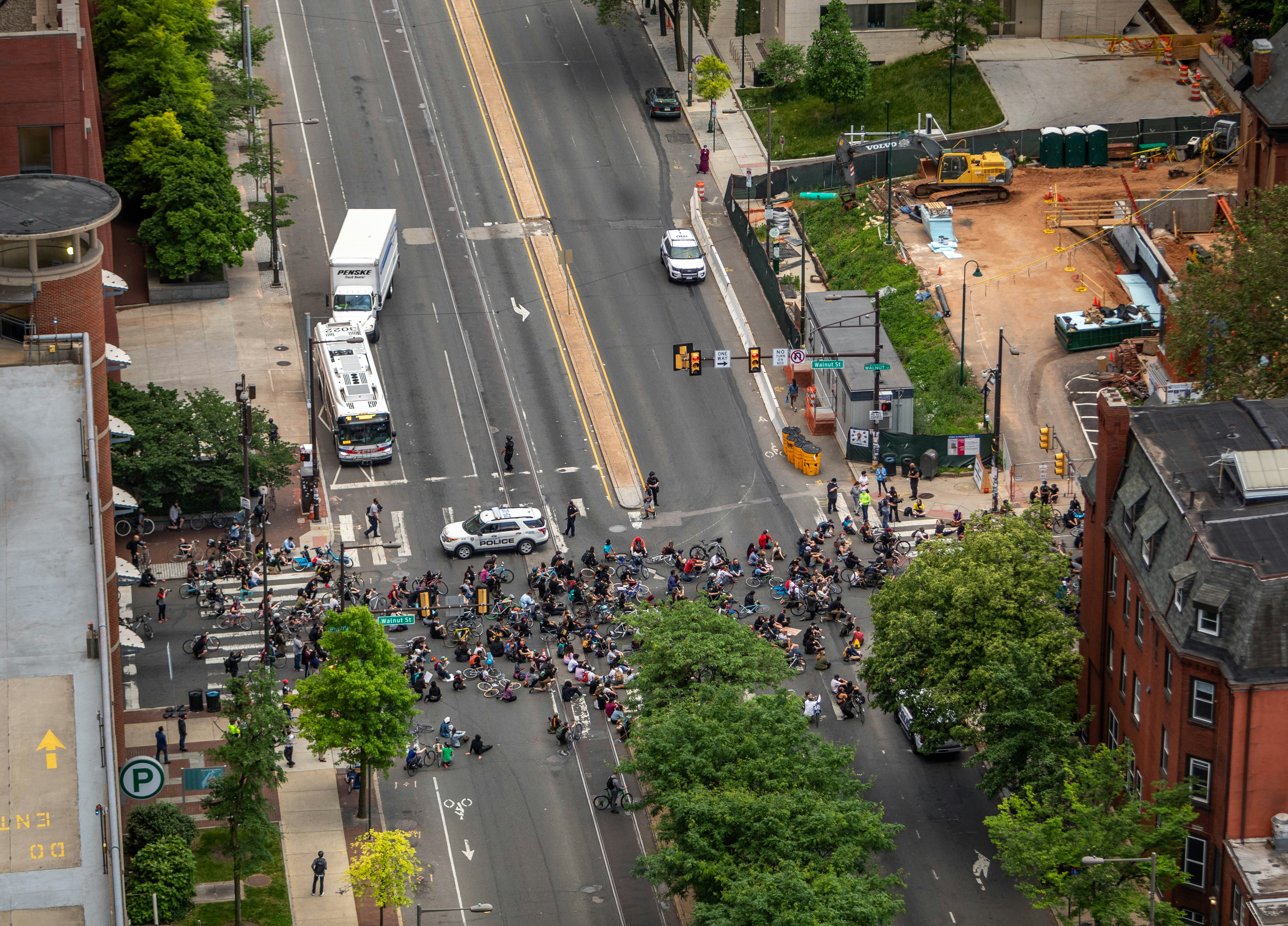 a group of people standing on the side of a road