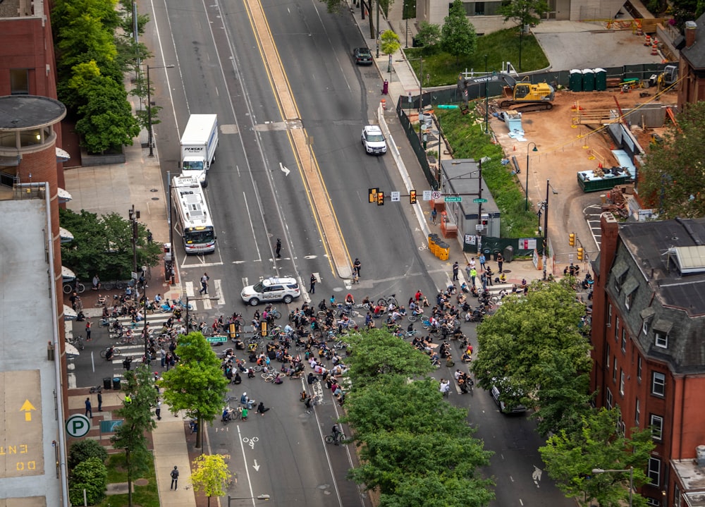 a group of people standing on the side of a road