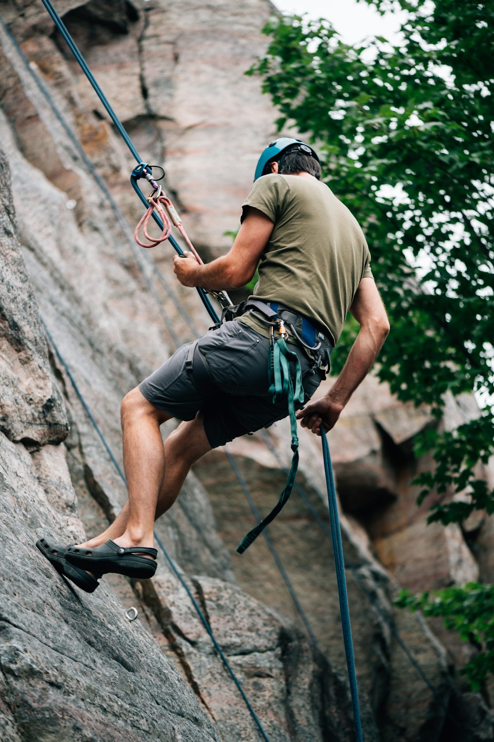 a man climbing up the side of a mountain