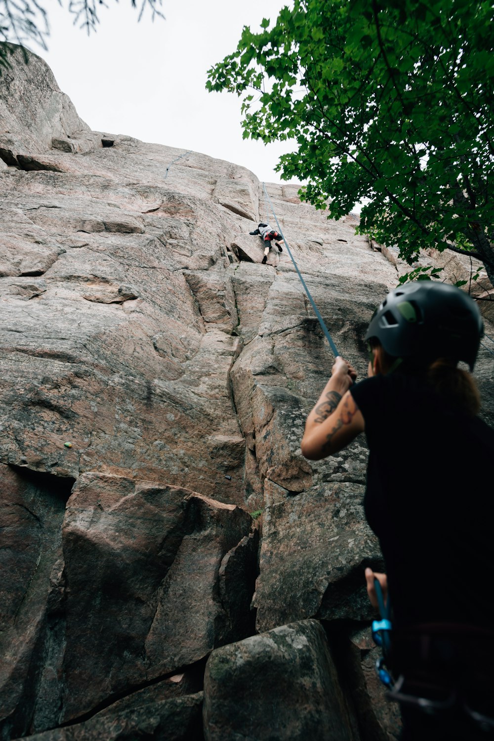 a man climbing up the side of a mountain