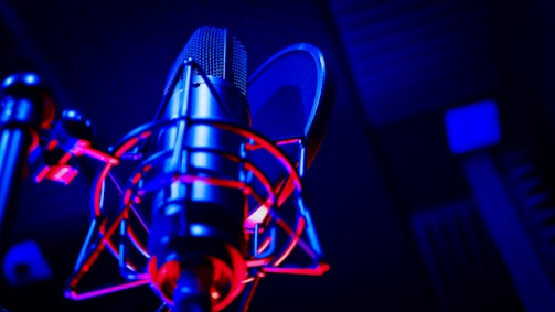 A lively radio studio microphone with colorful sound waves in the background.