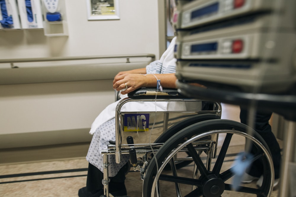 a woman sitting in a wheel chair in a hospital